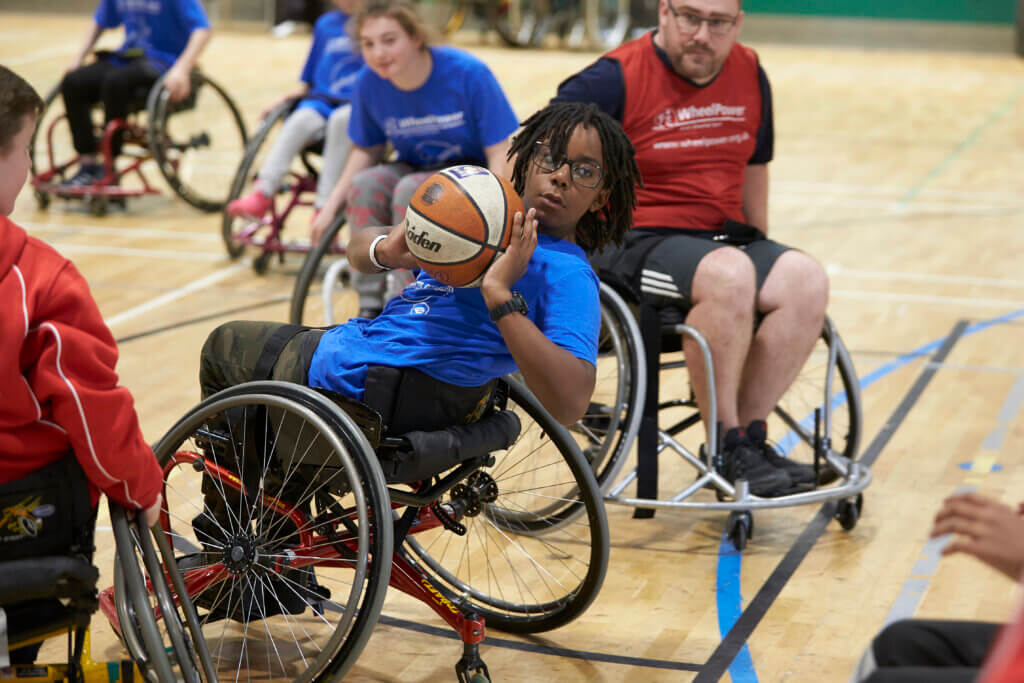 Teenager playing wheelchair basketball at WheelPower National Junior Games 2019