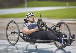 Hand cyclist cycling in the rain