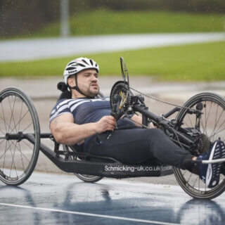Hand cyclist cycling in the rain