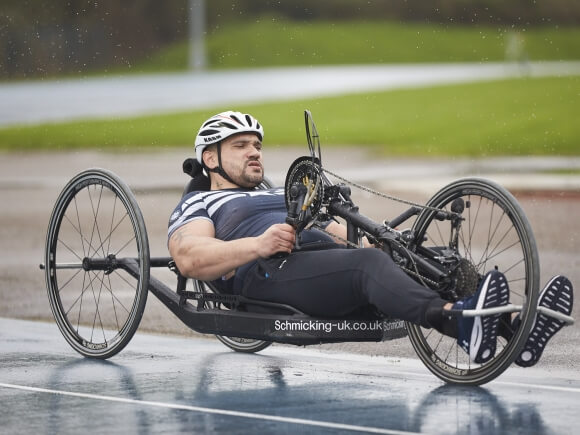 Hand cyclist cycling in the rain