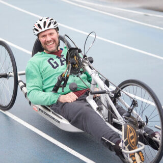 Hand cyclist cycling at Stoke Mandeville Stadium
