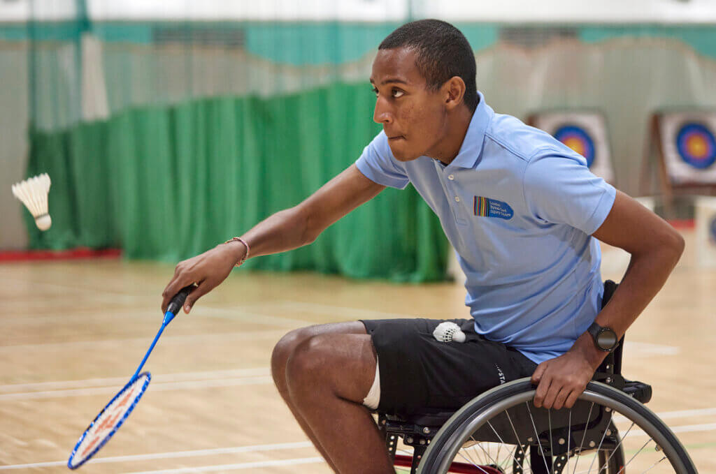 Wheelchair badminton player in action