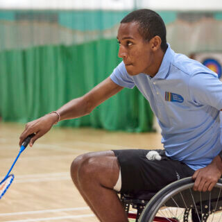 Wheelchair badminton player in action