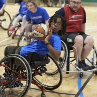 Young wheelchair basketball player dring a match