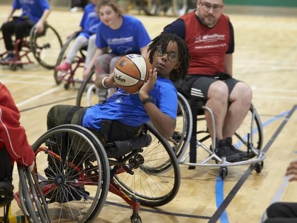 Young wheelchair basketball player dring a match