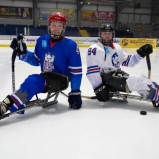 Two GB para ice hockey players posing for the camera