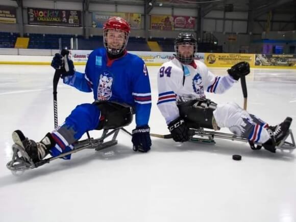 Two GB para ice hockey players posing for the camera
