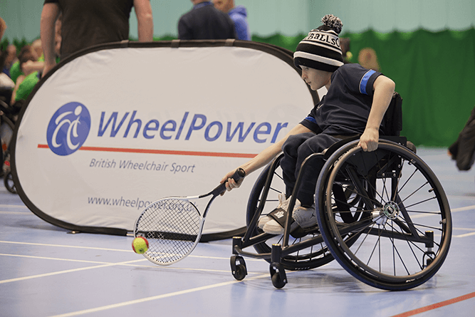 wheelchair tennis player in bobble hat