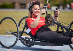 close up of a young hand cylist on the track smiling in the sunshine