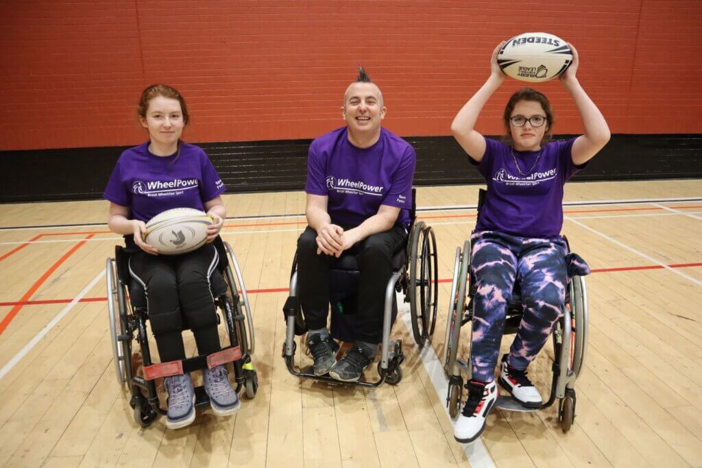 Three wheelchair users ready to play wheelchair rugby league